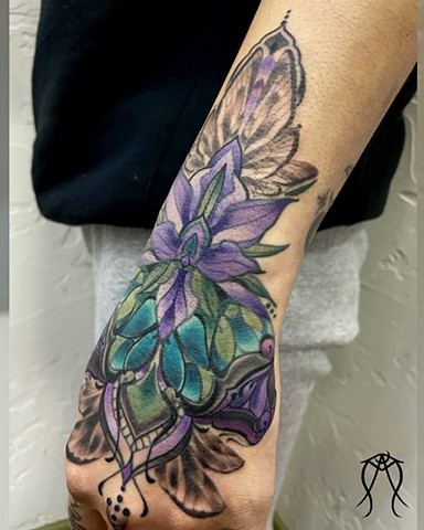 This is a color and black and grey hand ornamental floral butterfly wing tattoo done by female tattoo artist and tarot reader Amanda Marie in her private tattoo and tarot studio ace of wands tattoo in Scipio center New York ithaca east coast floral nature