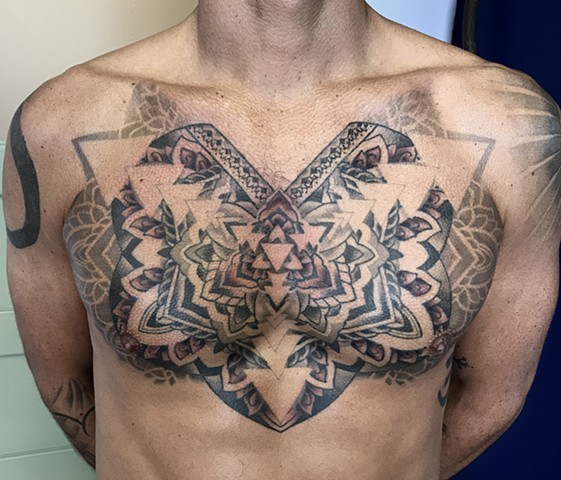 this is a chest piece that is geometric and sacred and spiritual that is in progress by amanda marie tattooer at ace of wands private tattoo studio in san pedro palos verdes los angeles california it is a high end intimate professional tattoo experience 