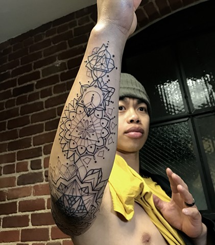 this is a tattoo in progress of chakra mandalas mandala geometric sacred geometry tattoo that is spiritual and done by Amanda marie tattoo artist in Los Angeles San Pedro South Bay California at private tattoo studio ace of wands tattoo 