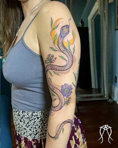 Sacred serpent snake and plant spirit color and black and grey tattoo green witch tattoo done by female tattoo artist tarot reader and pagan green witch in her private tattoo studio in Scipio center New York central Ithaca floral nature ornamental geometr