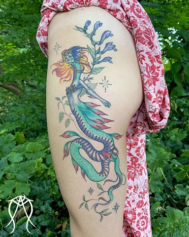 This is a mythological celestial siren dragon tattoo done in color by Amanda Marie female tattoo artist and tarot reader in her private studio in Ithaca New York Scipio center New York east coast tattoo it feature plant spirit art and magick 