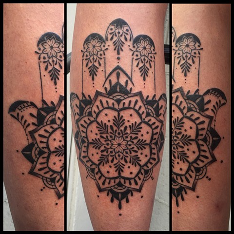 this is a tattoo of a hamsa that is done including a mandala and a geometric style in black and grey by female tattooer amanda marie at evermore tattoo in los angeles california 