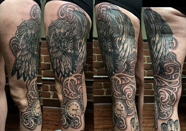 this is a tattoo done in a gothic dark art style by amanda marie tattooer of an owl spirit animal with a mandala halo and a pocket watch done in black and grey with soft shading amanda works at ace of wands tattoo in san pedro los angeles california 