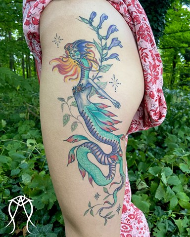 This is a mythological celestial siren dragon tattoo done in color by Amanda Marie female tattoo artist and tarot reader in her private studio in Ithaca New York Scipio center New York east coast tattoo it feature plant spirit art and magick 