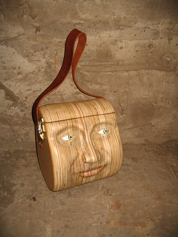 purse sculpture head carving face wood leather 