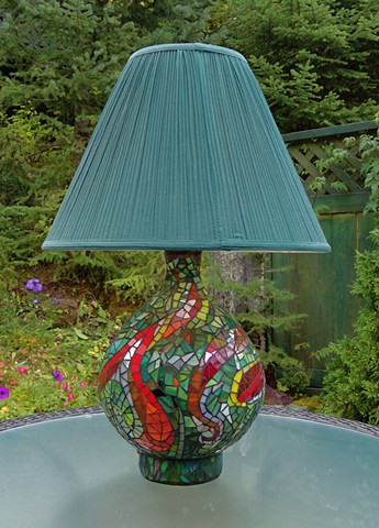 A recycled lamp base covered with an abstract design in stained glass