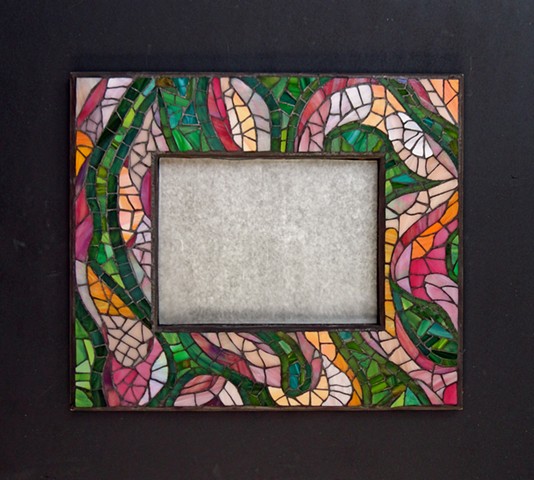 An abstract mirror frame with the colours I love in a garden in summer