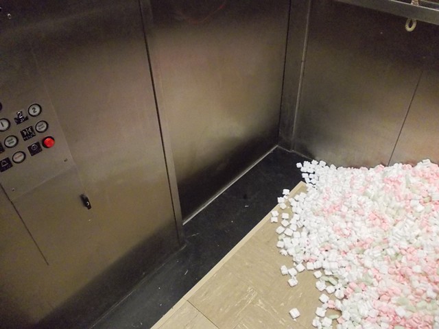 Art sculpture site-specific installation packing peanuts public elevator sedentary vs. movement travel mobility stability by Jenna Knoblach