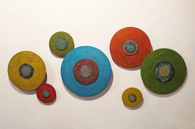 Abstract encaustic wall sculpture on acrylic circles in bright colors