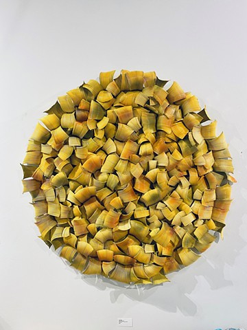 circle mixed-media aluminum wall sculpture in yellow orange green and red 