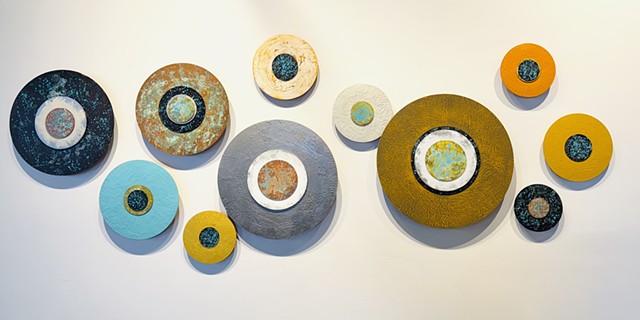 rust, metallic, silver, black, colorful circular paintings wall art installation abstract