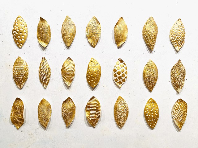 Encaustic gold and white seed organic wall sculpture on white clay ceramic