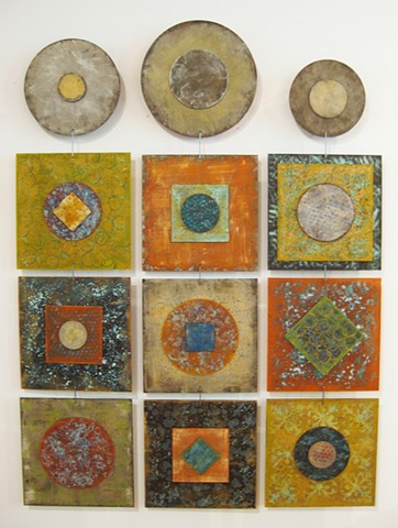 Hanging wall art sculptures with circular and square panels, orange and metallic finishes