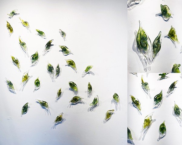 Hand-blown glass leaf wall sculptures art installation green leaves swirling in the wind 