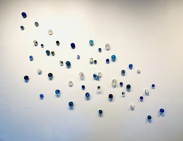 Blue glass wall sculpture water pebbles art installation modern abstract