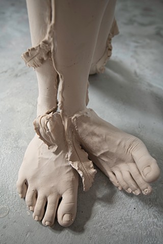 contemporary life cast sculpture of feet and leaves