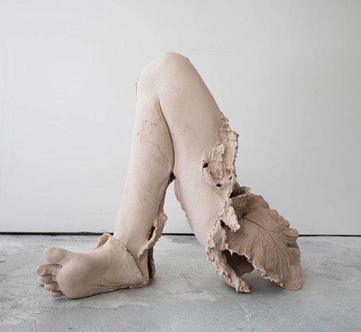 life casted leg, feet, and plant sculpture