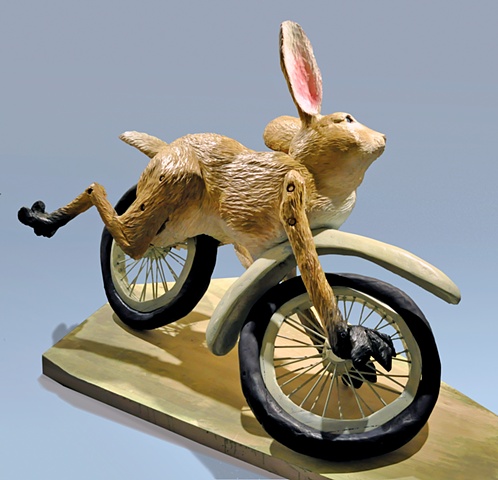 rabbit on wheels, mid-wipe out, struggles to hold on. 