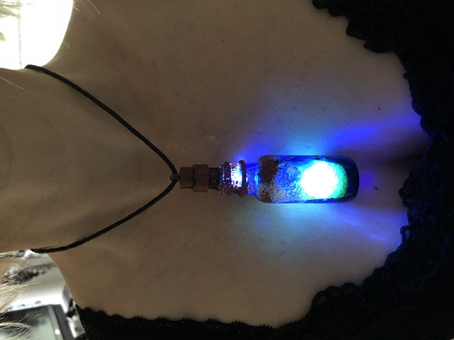 Glowing Blue Bottle Pendant