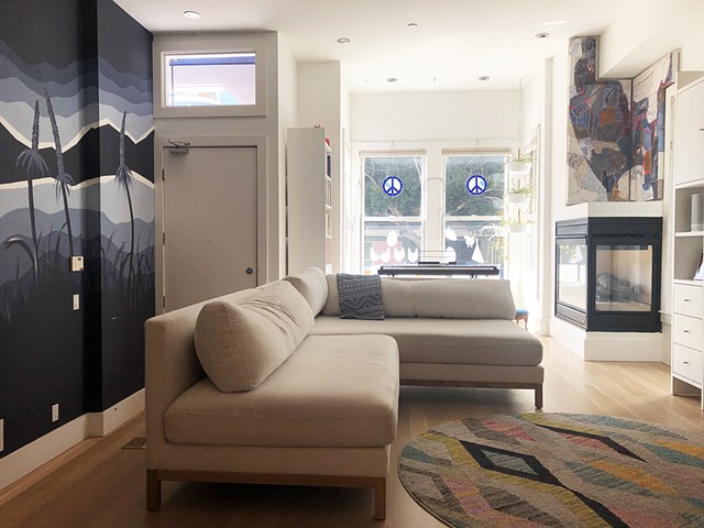 Installation view in Hayes Valley victorian, pictured with adjacent mural by Rhonel Roberts