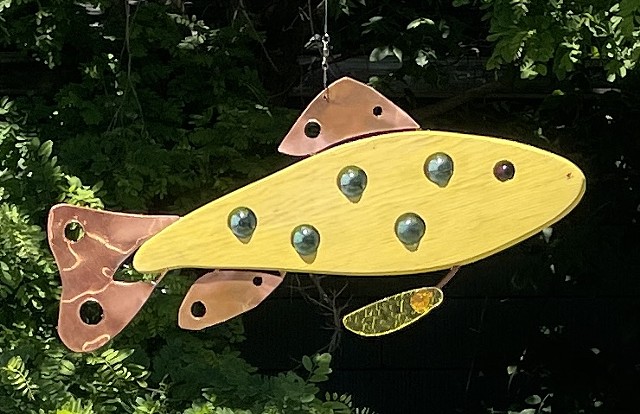 hanging trout sculpture.