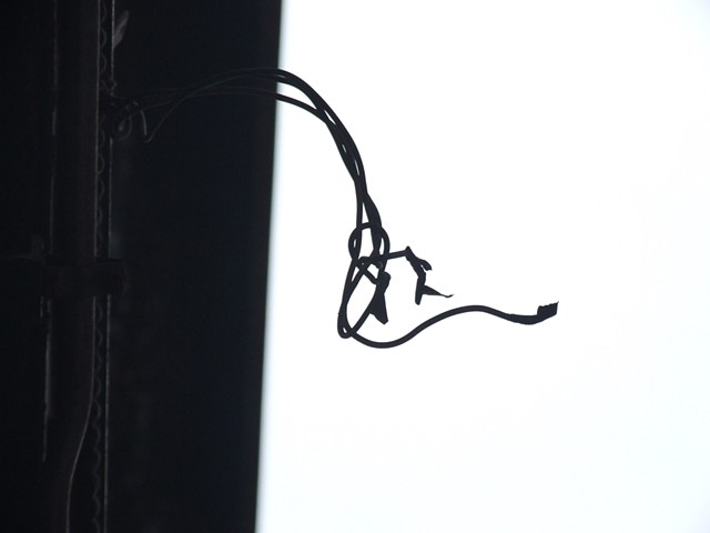 photograph of an electrical wire hanging off of Sullivan's Carson, Pirie, Scott building
