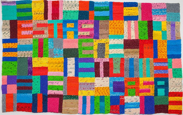 Estas En Tu Casa (this is your home) is a large crocheted plastic bag floor piece. 