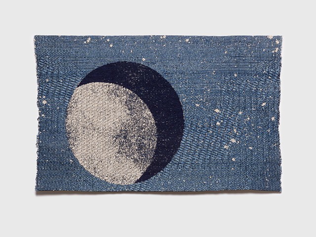 Waining cresent moon depicted on textural stary background