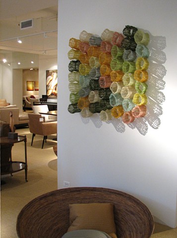 Organic geometric grid crocheted fiberglass and polyester resin wall sculpture based on Pi by Yvette Kaiser Smith