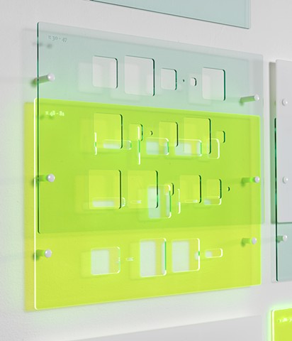 Green, blue, and white laser-cut acrylic template grid installation based on pi by Yvette Kaiser Smith