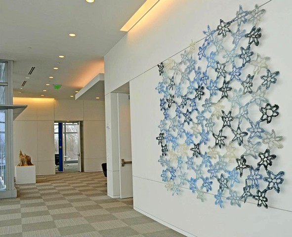 Crocheted fiberglass and polyester resin flower grid wall sculpture by Yvette Kaiser Smith