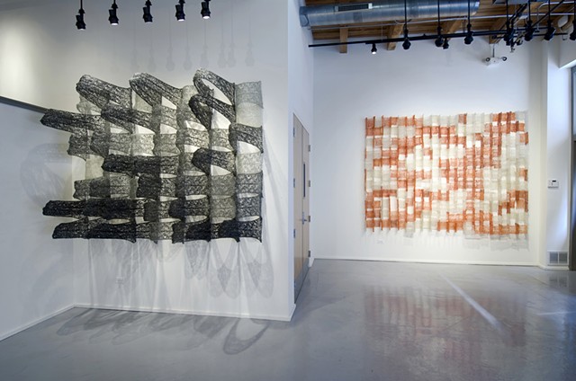 Geometric architectural grid crocheted fiberglass and polyester resin wall sculpture based on the numbers pi and e by Yvette Kaiser Smith