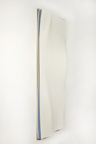 vertical organic undulating white felt revealing parts of light blue felt underneath