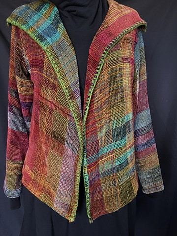 Handwoven lapel jacket of rayon chenille, cotton and bamboo yarns.