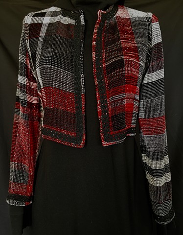 Handwoven bolero jacket of rayon chenille, cotton and bamboo yarns.