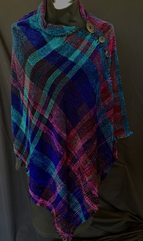 Handwoven Poncho of rayon chenille, cotton and bamboo yarns.  Hand-embellished with crochet and buttons.