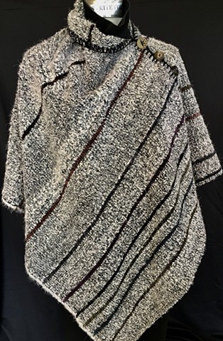 Handwoven poncho of rayon chenille, cotton and bamboo yarns.  Hand-embellished with crochet and buttons.