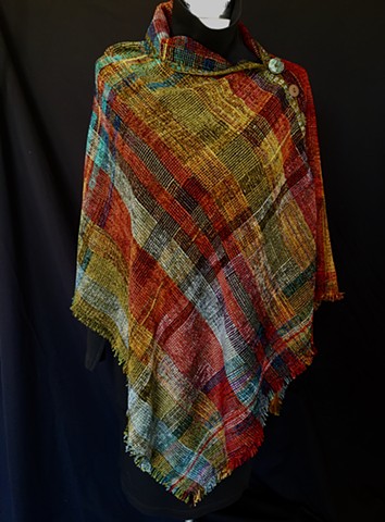 Handwoven Poncho of rayon chenille, cotton and bamboo yarns.  Hand-embellished with crochet and buttons.
