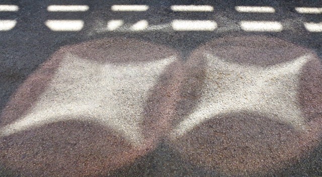 Digital Photograph of light reflections on asphalt. 