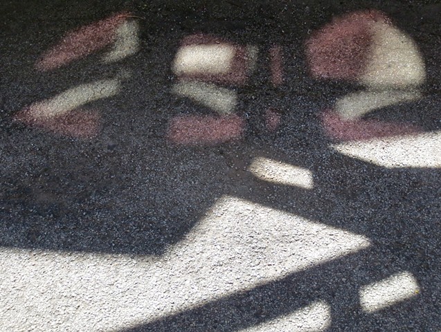 Digital Photograph of light reflections on asphalt.