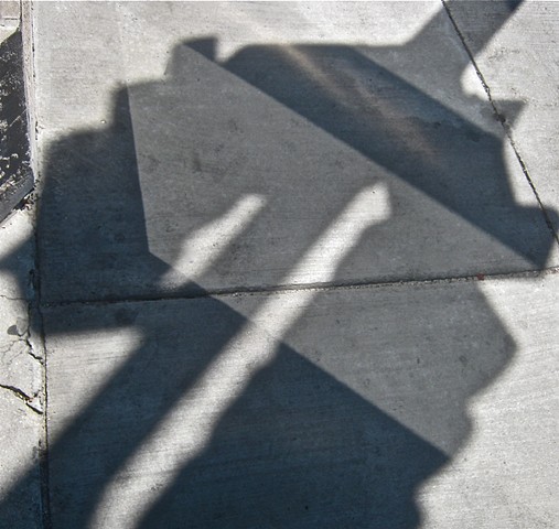 Digital photograph of light reflections and shadows on sidewalk 