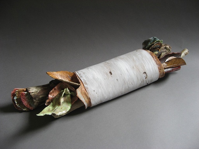  This piece has a combination of bark,sticks, fungus, and leaves made from porcelain.