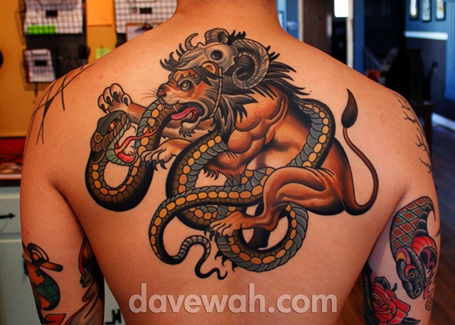 lion fighting snake tattoo by dave wah at stay humble tattoo company in baltimore maryland