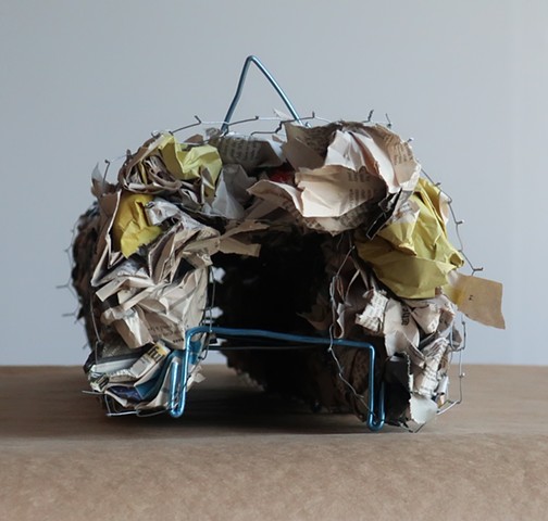 Robert Fields, "It's just something I brought with me." 2019.  Galvanized poultry netting, paper (NYTimes), and anodized aluminum wire.7 H x 33 W x 9 D Inches. Contemporary sculpture.