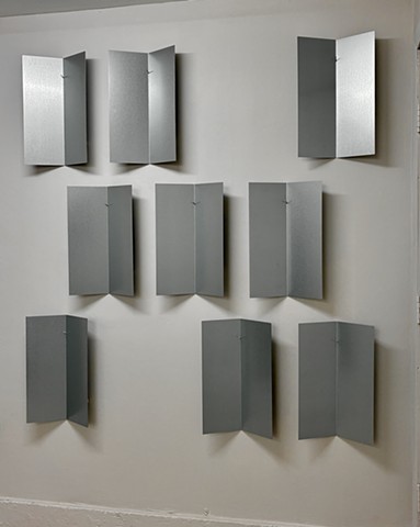 Sculpture, Contemporary Art, Conceptual Art. Minimal Art. Bob Fields,"UNTITLED"  (Nine Folded Plates), 2026. Galvanized steel. 66 ½ x 62 x 3 ½ inches overall. Plate: 19 ½ x 12 ½ x 3 ½ inches. Installed: 89 ½ inches high @ 23 inches AFF.  