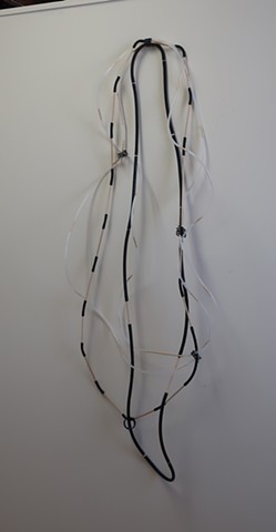Robert Fields, "#3...Untitled," 2020. Material: Tubing (neoprene, vinyl and polyethylene), wood, and vinyl jacketed copper wire. 56" H x 20" W x 7" D. Contemporary minimal sculpture. Wall mounted.
