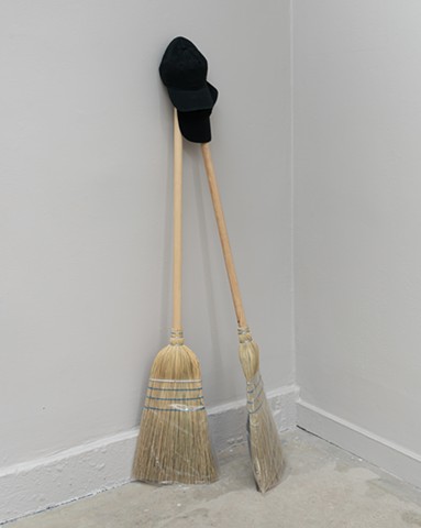 Sculpture. Conceptual Art, Minimal Art. Contemporary Art.   BOB FIELDS, “If I am only for myself, what am I?” , 2026.  Baseball caps, a pair, and brooms (2),  58 x 24 x 18 Inches.