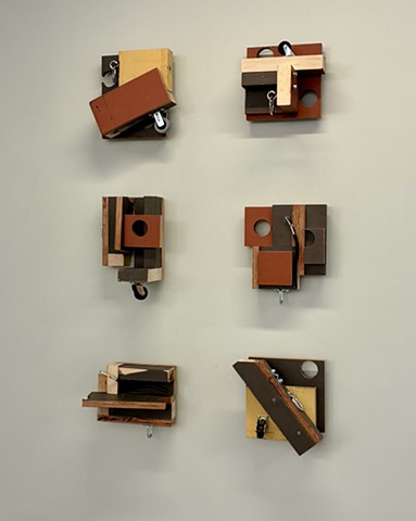 Contemporary Art, Minimalism, sculpture, Wall sculpture, Robert Fields, Artist.  UNTITLED ("To be alive is to be uncertain."  ~ Arthur P. Bochner), 2014-2025.  Graphite, wax crayon, weathered wood (repurposed from an older work) . . . plus electric cord + a variety of hardware, 46 " x 28" x 7".