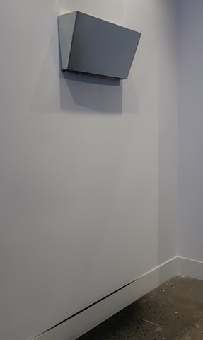 Robert Fields, "We need to work through this." 2019. Galvanized steel and charcoal. 74 H x 24 W x 6 D Inches. Contemporary sculpture, minimal... quietly leaving chance marks and traces of charcoal on the wall and floor below.