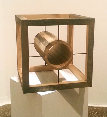 This wooden cube is made from 100 year old salvaged lumber and rusted steel rods.